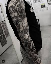 Angel Dove And Roses Flowing Together In A Full Sleeve Full Sleeve Tattoos Tribal Arm Tattoos Tribal Tattoos For Men