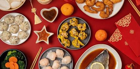 Lunar New Year reunion feast showcasing symbolic dishes.