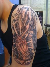 Green and black celtic cross tattoo on man left half sleeve. Religious Tattoos For Men Designs Ideas And Meaning Tattoos For You