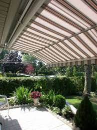 Retractable Awnings With The Marcesa Feature Offer Much Higher Headroom To Open Up Your Outdoor Patio Space Retracta Outdoor Awnings Pergola Patio Landscaping