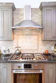 Mosaic Backsplash With Framed Tile Design Above Cooktop Wall Oven Wall Oven Wall Oven Kitchen Kitchen Remodel Small