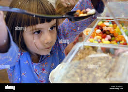 Quincy Johnston (cq), 6, helps herself to jelly beans, a topping for her  yogurt at Yougurtopia in Sacramento, July 17, 2007. Sacramento Bee/ Florence  Low Stock Photo