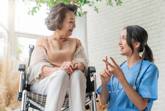 Disability support worker assisting a client at home