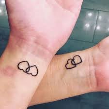 Three black tribal heart tattoos on arm. 28 Cute Small Heart Tattoo Ideas For Women Styleoholic