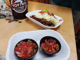 Place some fish into a warmed tortilla and top off with sliced cabbages, mango salsa and queso fresco. Fish Taco And Salsa Fresca And Tofino Brewery Beer Picture Of Tacofino Cantina Vancouver Island Tripadvisor
