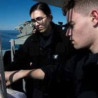 Capt. Jeffery Cole, left, Rear Adm. Matthew Kohler, commander of Navy  Information Dominance Forces, Linda Johnson, mayor of Suffolk, Va., and  Information Systems Technician Seaman Nicholas Richardson cut the official  cake. -
