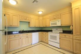white kitchen appliances, maple kitchen