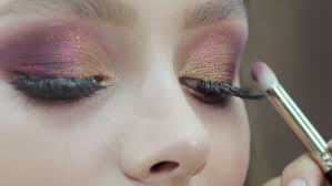 applying eyeshadow eye makeup close up