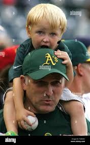 Nick Babiak,3, celebrates his third birthday riding atop his dad's, John,  shoulders prior to the Rockies hosting an interleague game with the Oakland  Athletics at Coors Field in Denver June 21, 2006.