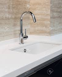 Shop our curated home furnishing collections today. Detail Of A White Rectangular Designer Kitchen Sink With Chrome Water Tap Against A Tiled Wall Stock Photo Picture And Royalty Free Image Image 104290656