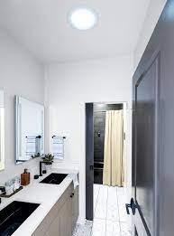 Galley bathroom with double vanity sink cote. Sun Tunnel Skylights Brighten Bathrooms