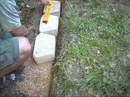 Leave the concrete in the bag, stack like legos, wet with a hose. Building A Concrete Block Retention Wall Youtube