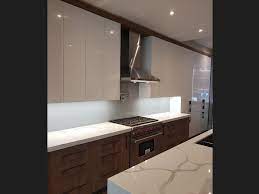 Neutral square mosaic glass tiles blend with granite countertops. Glass Sheet Kitchen Backsplash Vs Glass Tile Backsplash How To Choose Cbd Glass