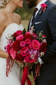 Bright fuschia bridal bouquet of orchids peonies tulips. Obsessed Over This Bright Romantic Bridal Bouquet In Hot Pink And Red The Combination Of Pink Rose Wedding Bouquet Red Wedding Theme Hot Pink Wedding Flowers