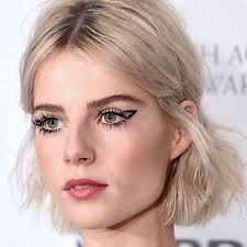 Emma roberts, kiernan shipka, and lucy boynton try to summon spirits with a ouija board. The Best Of Lucy Boynton S Red Carpet Beauty Looks Savoir Flair