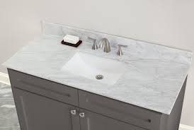 Installing black marble countertops in your bathroom can lead to a great shine when paired with white vanity cabinets. Bianco Carrara Marble 49 In Vanity Top Includes Backsplash 49in 100583954 Floor And Decor