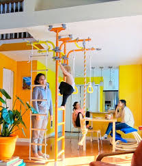 Play Gyms For Kids For Home Use Tension Mounted Floor To Ceiling Or Wall Mounted Frames With A Variety Of Ad Kids Gym Kids Indoor Playground Indoor Playground