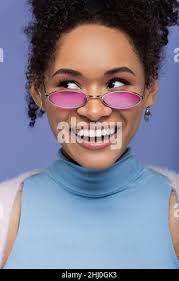 happy young woman in violet rain coat looking at camera isolated