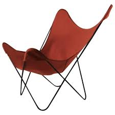 Period midcentury butterfly chair, having a wrought iron frame and original black canvas sling seat. Hardoy Butterfly Chair With Original Orange Canvas Sling Seat At 1stdibs