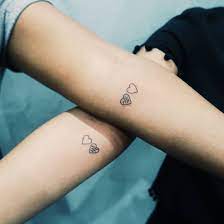 Matching Friendship Heart Tattoos Inked On Forearms Tattoos Heart Tattoo Matching Couple Tattoos