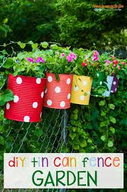 A fence gives clearly delineate a garden from the rest of the yard while adding a bit of personality and style to an outdoor space. Tin Can Flower Garden I Should Be Mopping The Floor