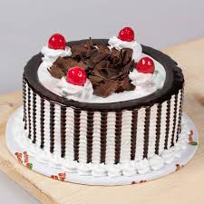 Chocolate cake with cherries on white marble background. Black Forest Cake Shree Mithai