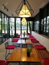 Besides good quality brands, you'll also find plenty of discounts when you shop for coffee shop table during big sales. Coffee Shop Interior With Wooden Tables Red Chairs Plant And Stock Photo Picture And Royalty Free Image Image 79842122