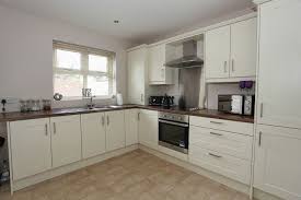 ivory kitchen with plum butchers block
