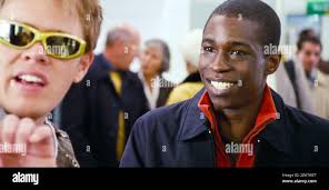 REGNO UNITO. Abdul Salis in una scena del film ©Universal Pictures :  l'amore in realtà (2003). Trama: Segue la vita di otto coppie molto diverse  nel trattare con la loro vita d'amore