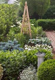 First, you create one side of the trellis—a ladder shape with two legs and five rungs. Diy Garden Obelisk The Garden