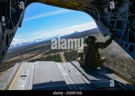 U.S. Army Staff Sgt. Manuel Rodriguez, a CH-47F Chinook helicopter flight  engineer from B Company, 1st Battalion, 52nd Aviation Regiment, observes  the environment during Northern Edge 2021 (NE21) over the Joint Pacific  Alaska Range Complex ...