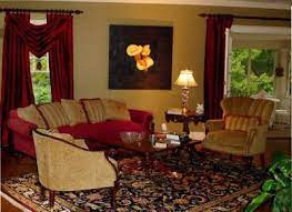 Large living room featuring gray walls and a gray couch, along with a large area rug and a fireplace. Burgundy Gold Living Room I Like The Arrangement Of The Furniture Burgundy Living Room Gold Living Room Gold Bedroom