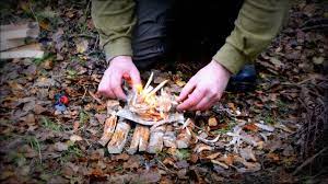 Strike your match and immediately cup it in your hands to protect it from rain and wind. How To Start Fire In The Rain Youtube
