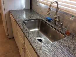 New caledonia granite is one of the more beautiful granite kitchen countertops that can add value and modern style to the most important room in your home. Caledonia Granite With Backsplash Tiles