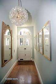 How To Make A Narrow Or Long Hallway Feel Wider And Brighter Photo Via Location Works Narrow Hallway Decorating Narrow Hallway Long Narrow Hallway
