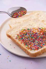 Lay the bread, butter side down, in the sprinkles and press gently on the bread to make sure as many sprinkles as possible adhere to the butter. How To Make Fairy Bread Kid S Party Treat Sweetest Menu