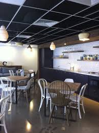 Charcoal And Timber Kitchen With Matt Subway Tiles In Student Breakout Space Ceiling Panels Removed To Crea Office Ceiling Tiles Timber Kitchen Ceiling Design