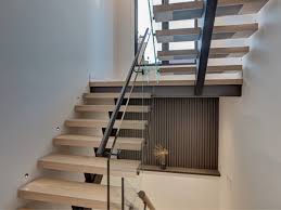This floating staircase aligns each step with each shelf creating a cool structured and graphic visual. Traditional Stair Case Designs By Berman Stairs Inc