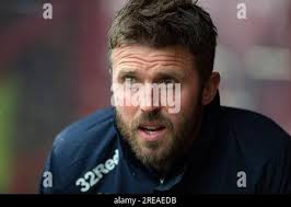 Bradford City football manager Trevor Cherry, a former Huddersfield town  player who lives at Lepton, is presented with a £200 cheque for the fire  disaster fund by Lepton Middle School pupils Matthew