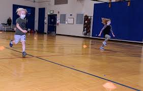 Portrait of careless smiling doctor physician posing at camera. Fort Leavenworth Youth Sports Clinics Keep Children Active Article The United States Army