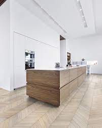 Fantastic kitchen with cow art on diagonal wood paneling situated across from large kitchen island eugene pendants illuminate a black kitchen island fitted with legs and a white quartz countertop seating backless wood and metal. 75 Beautiful Modern Kitchen Island Pictures Ideas Houzz