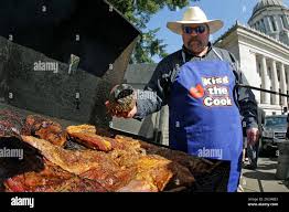 Larry Olberding, of Connell, Wash., sprinkles dry rub