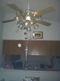 Use Fishing Wire To Hang Ornaments On Ceiling Fan Be Sure To Deck Them Out With Some Snow Christmas Interiors Christmas Interior Decor Christmas Decor Diy