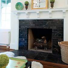 This natural stone surround makes an impressive visual display, moving right up to the sloped ceiling, and drawing the eye upward to emphasize the height and shape of the room. Fireplace Boasts Black Marble Surround White Mantel Marble Fireplace Surround Fireplace Tile Surround Black Marble Tile
