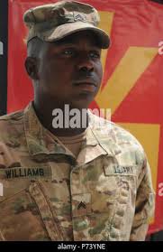 A Soldier with the Battery B, 1st Battalion, 43rd Air Defense Artillery  Regiment, 69th Air Defense Artillery “Top Notch” Brigade signals another  Soldier when to stop rotating the MIM-104 Patriot launching station