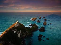 Ice nugget in sunset on a frozen lake in winter. Nugget Point Lighthouse New Zealand Amusing Planet