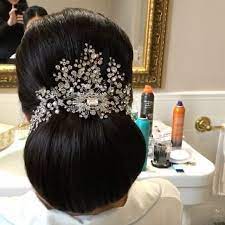 Fabulous Low Bun Bridal Hair Style Accented With A Sparkling Custom Head Piece Bridal Hair Low Bun Bridal Hair Bridal Hairdo