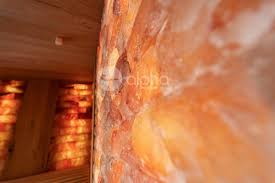 A custom-designed sauna where traditional warmth meets contemporary  elegance. Crafted with ergonomic cedar wood benches that offer both comfort  and durability, this luxurious space is enhanced by the ambient glow of  backlit