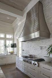 Backsplash for white cabinets herringbone backsplash beadboard backsplash backsplash renovation stacked stone backsplash metallic backsplash natural stone backsplash kitchen. French Range Hood With White Stone Backsplash Tiles Cottage Kitchen