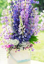 Bride holding yellow bouquet for wedding at mystical rose gardens in baldwin, wisconsin. Lupine Bouquet Lupine Flowers Purple Wildflowers Wedding Flowers